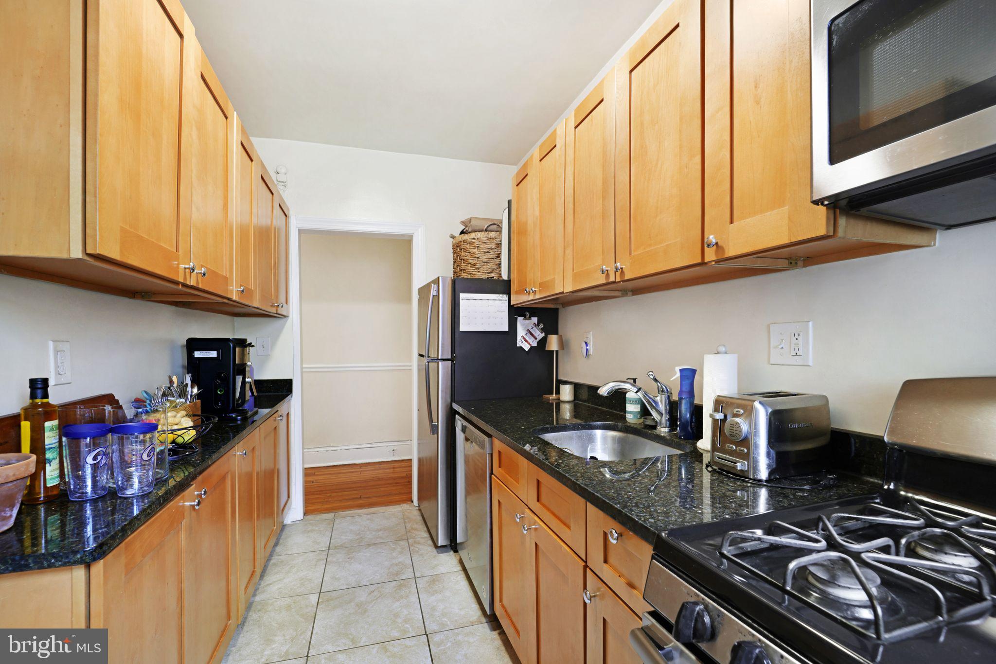 1426 12th Street Northwest, Unit 5 Washington, DC 20005 - Photo 10 of 21 a kitchen with stainless steel appliances granite countertop a stove and a sink
