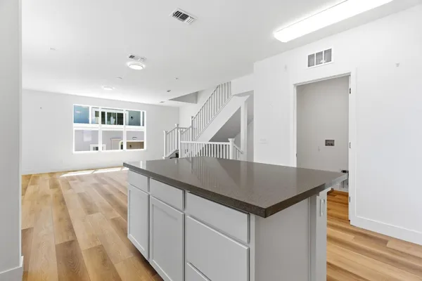 a kitchen with a stove a sink and a refrigerator