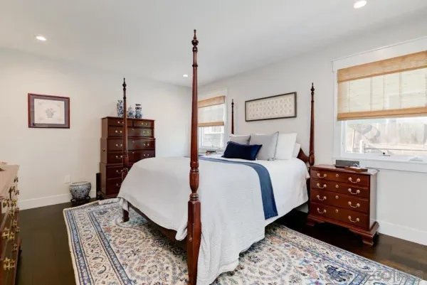 a bedroom with a large bed and a window