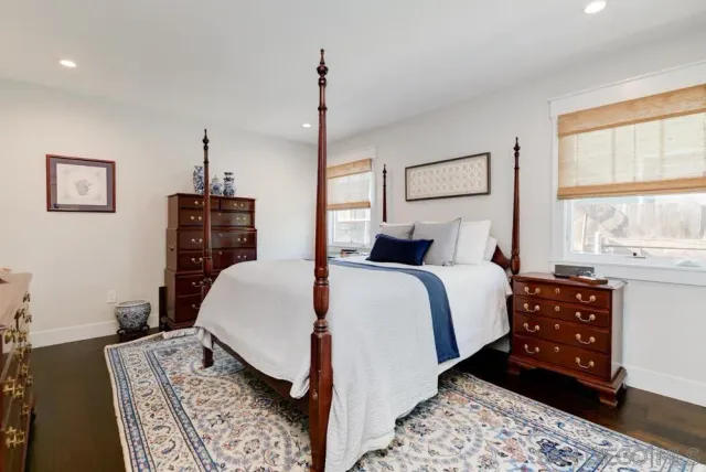 a bedroom with a large bed and a window