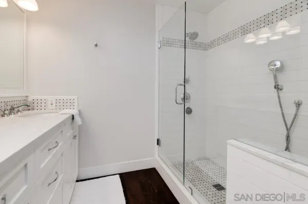 a bathroom with a shower and a sink