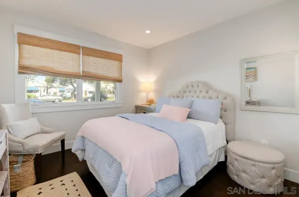 a bed room with a bed and a chair