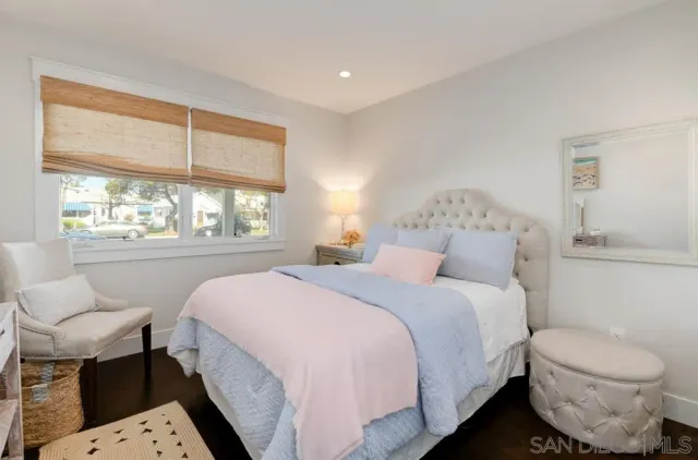 a bed room with a bed and a chair