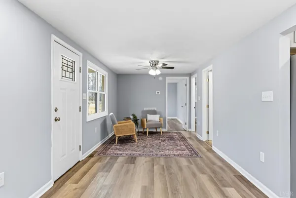 a view of a livingroom with wooden floor and a window