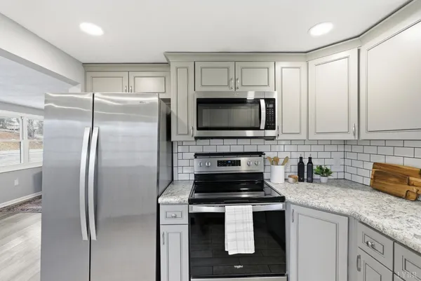 a kitchen with appliances a sink and cabinets