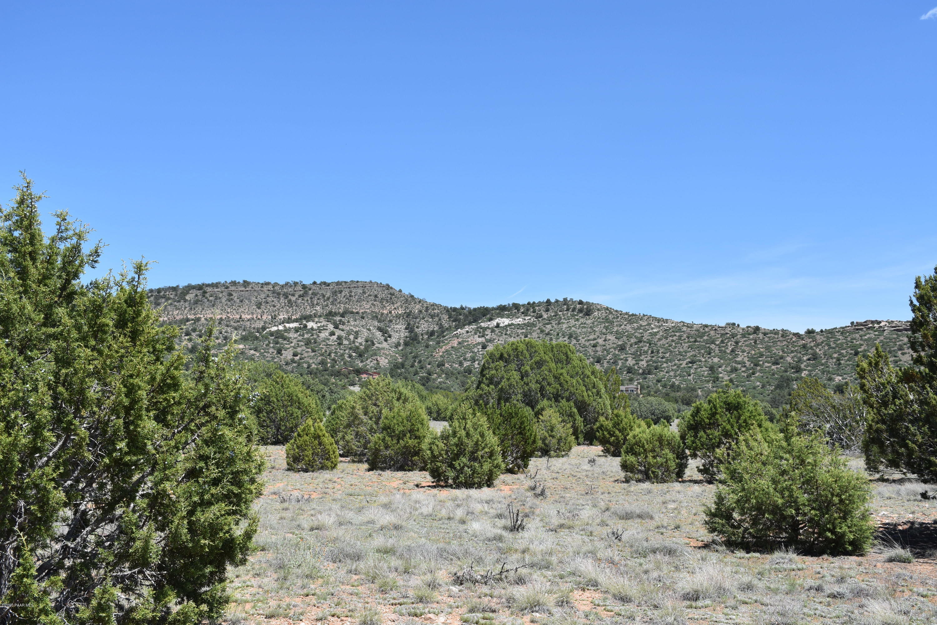 4930 West Sterling Ranch Road Prescott, AZ 86305 - Photo 1 of 22 a view of a dry yard with mountains in the background