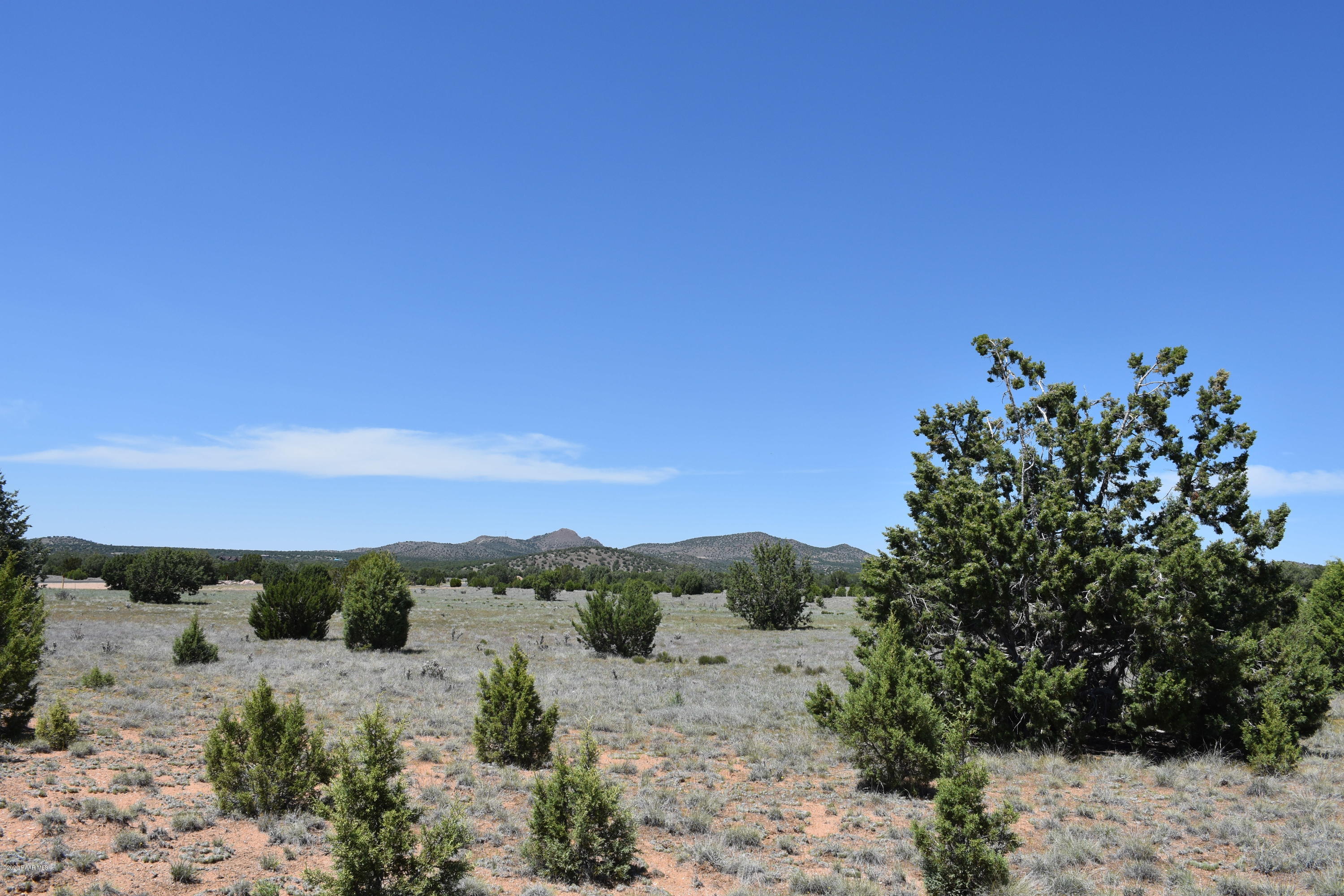 4930 West Sterling Ranch Road Prescott, AZ 86305 - Photo 3 of 22 a view of a dry yard with mountains in the background