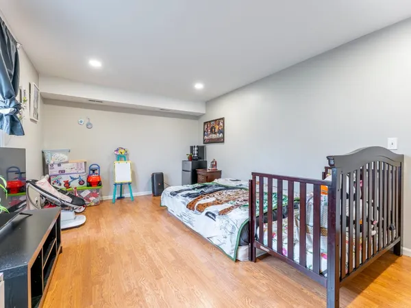 a bedroom with furniture and a wooden floor