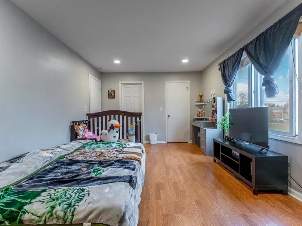 a bedroom with furniture and a flat screen tv