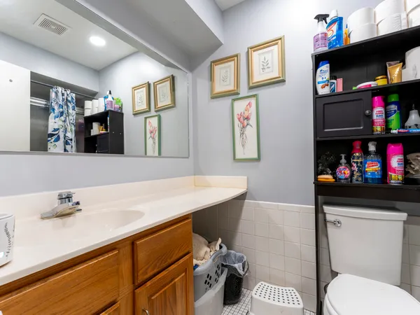 a bathroom with a sink a toilet and a mirror