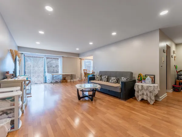 a living room with furniture and a wooden floor