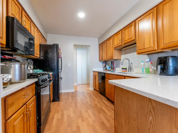 a kitchen with stainless steel appliances granite countertop a refrigerator stove top oven a sink and dishwasher