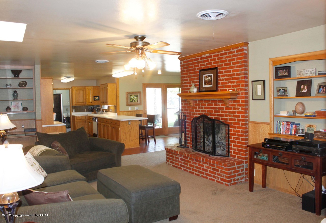 6104 Jameson Road Amarillo, TX 79106 - Photo 14 of 36 a living room with furniture kitchen view and a fireplace