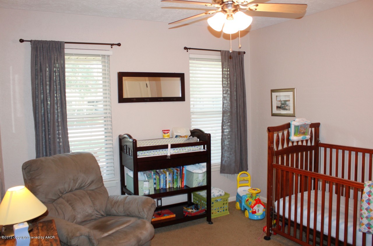 6104 Jameson Road Amarillo, TX 79106 - Photo 23 of 36 a bedroom with furniture and a window