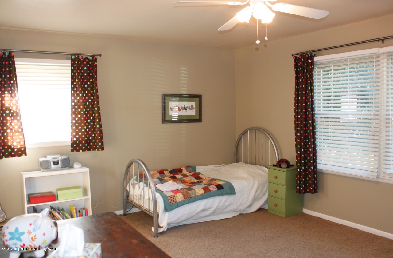 6104 Jameson Road Amarillo, TX 79106 - Photo 24 of 36 a bedroom with a bed and a window