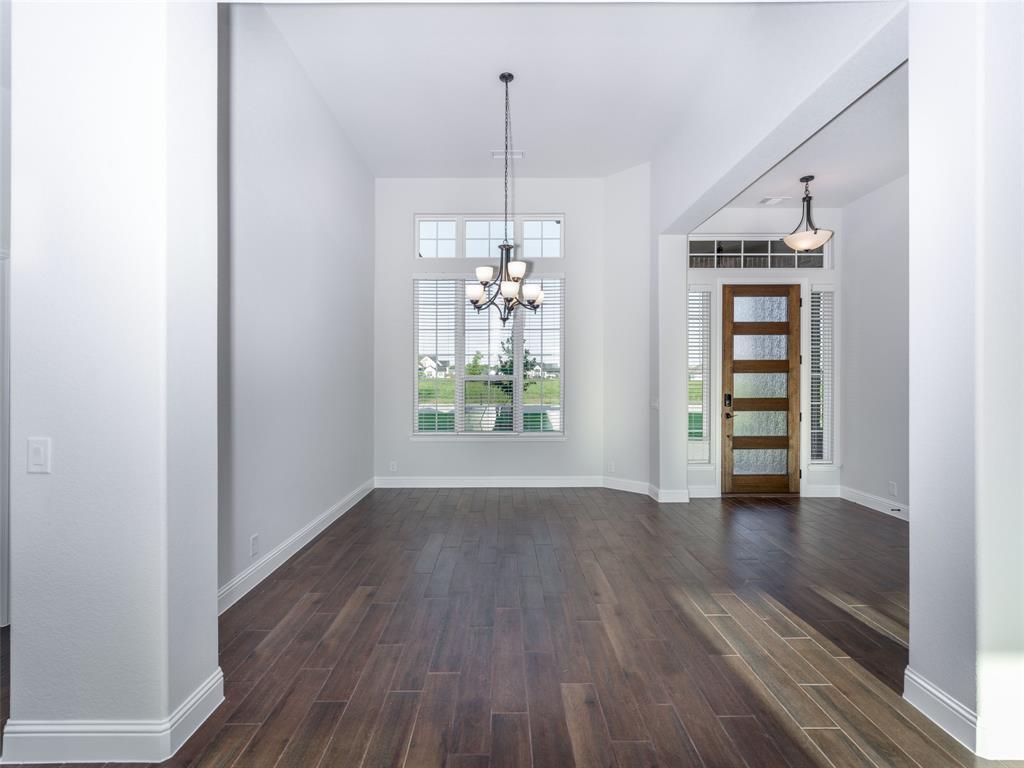 2108 Charters Circle Nevada, TX 75173 - Photo 5 of 37 Foyer entrance featuring dark wood-style flooring and a chandelier