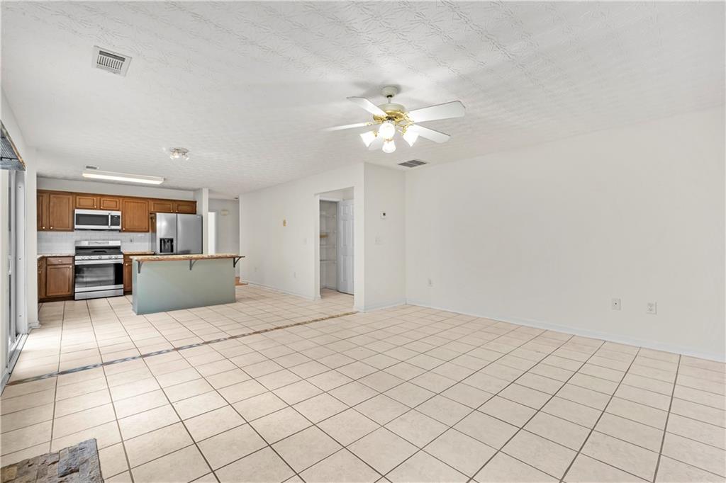 3740 Crescent Walk Lane Northeast Suwanee, GA 30024 - Photo 15 of 39 a view of a kitchen with microwave and cabinets