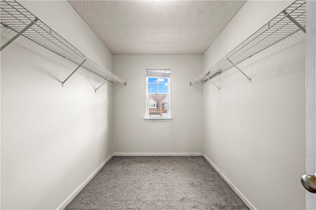 3740 Crescent Walk Lane Northeast Suwanee, GA 30024 - Photo 22 of 39 an empty room with a white wall & dryer