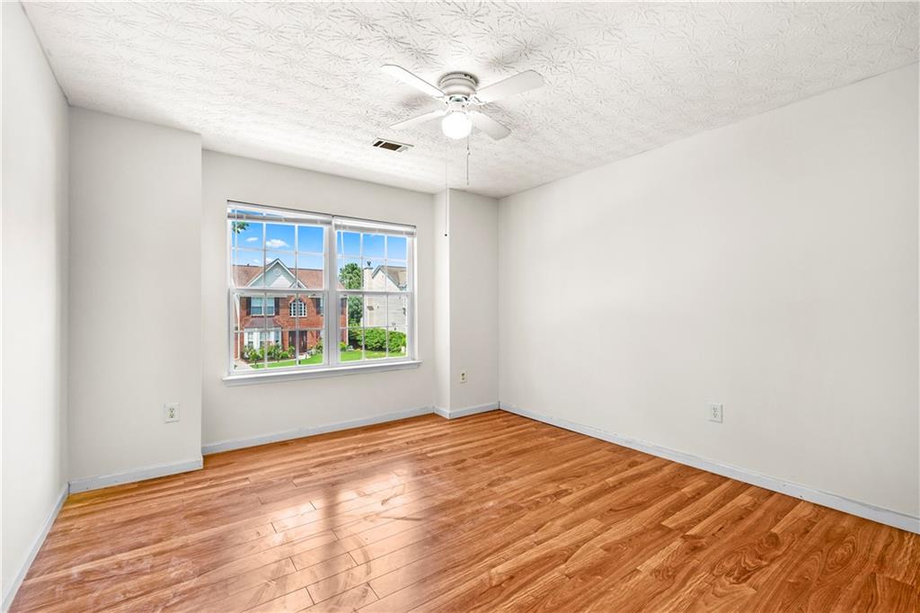3740 Crescent Walk Lane Northeast Suwanee, GA 30024 - Photo 25 of 39 wooden floor in an empty room with a window