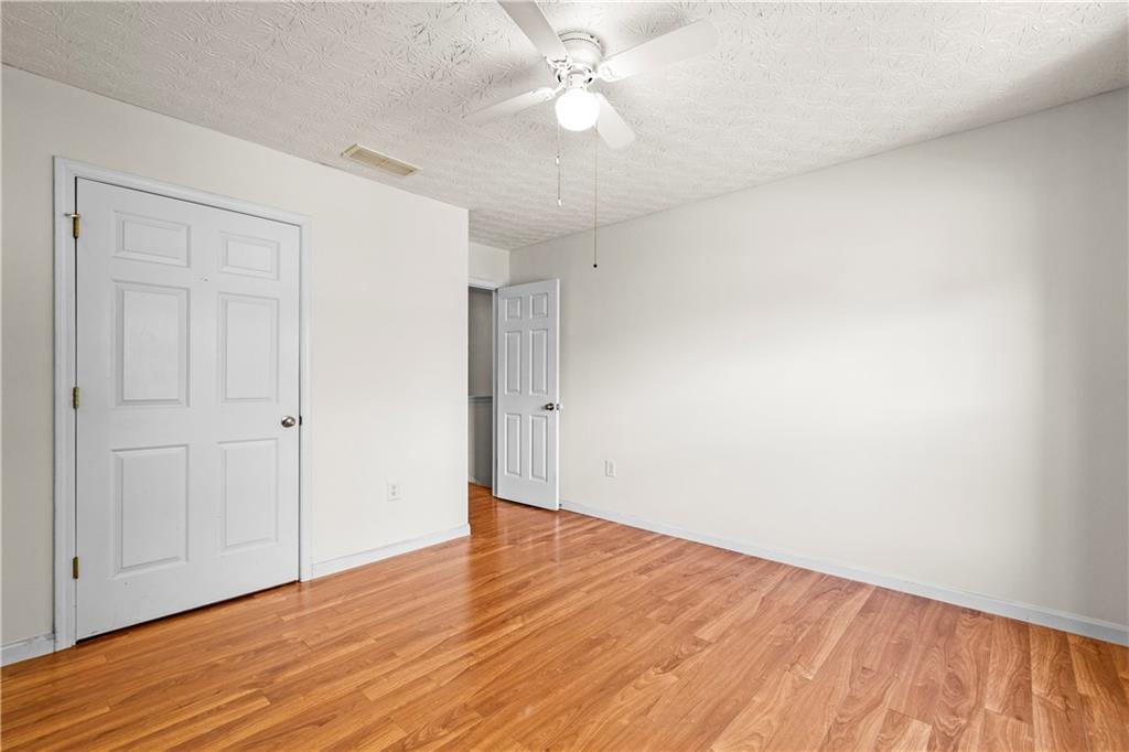 3740 Crescent Walk Lane Northeast Suwanee, GA 30024 - Photo 26 of 39 a view of an empty room with wooden floor