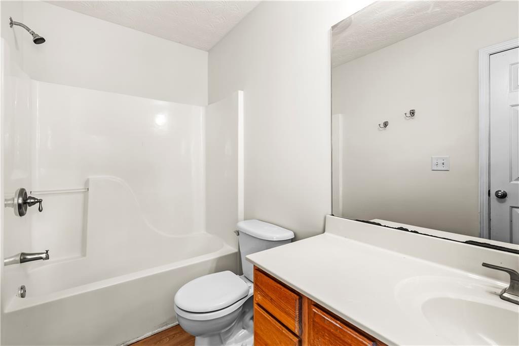 3740 Crescent Walk Lane Northeast Suwanee, GA 30024 - Photo 34 of 39 a bathroom with a sink a toilet and shower