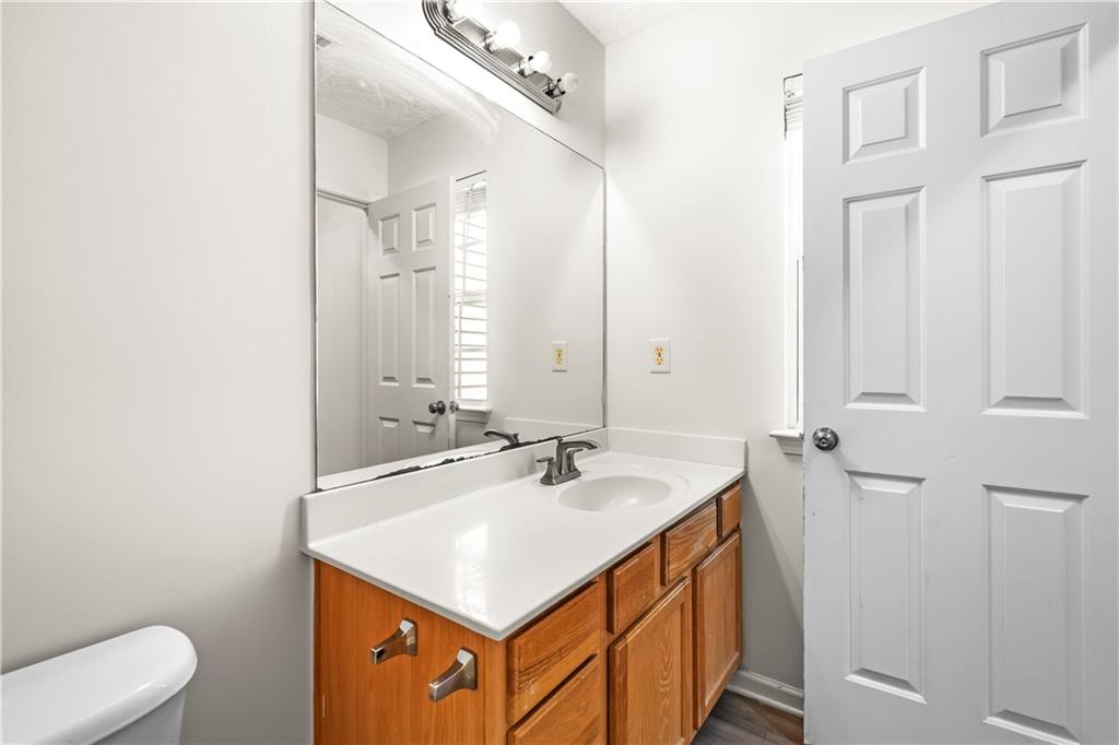 3740 Crescent Walk Lane Northeast Suwanee, GA 30024 - Photo 35 of 39 a bathroom with a sink a toilet and a mirror