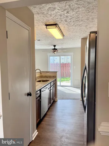 a kitchen with stainless steel appliances granite countertop a refrigerator and a stove