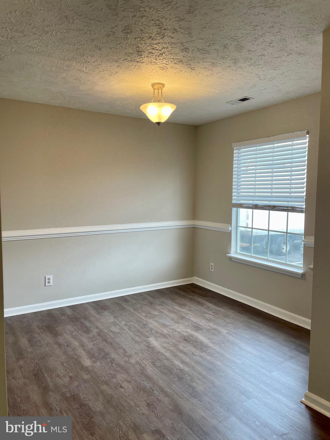 5126 Mallards Landing Drive King George, VA 22485 - Photo 10 of 19 an empty room with wooden floor and windows