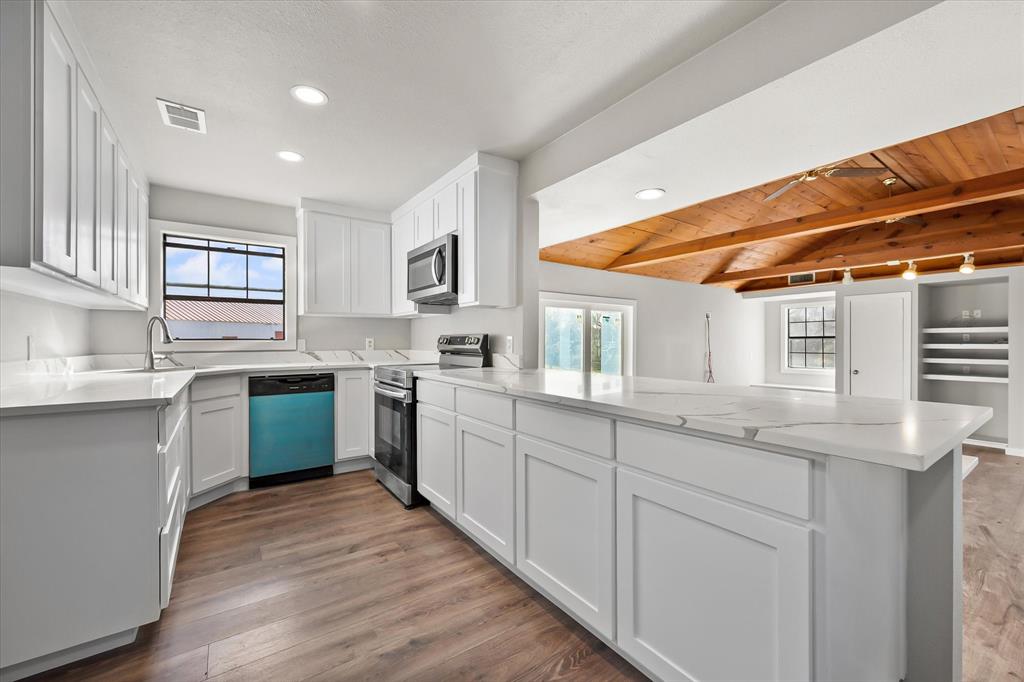 443 County Road 3799 Springtown, TX 76082 - Photo 12 of 33 a kitchen with stainless steel appliances granite countertop a sink and cabinets
