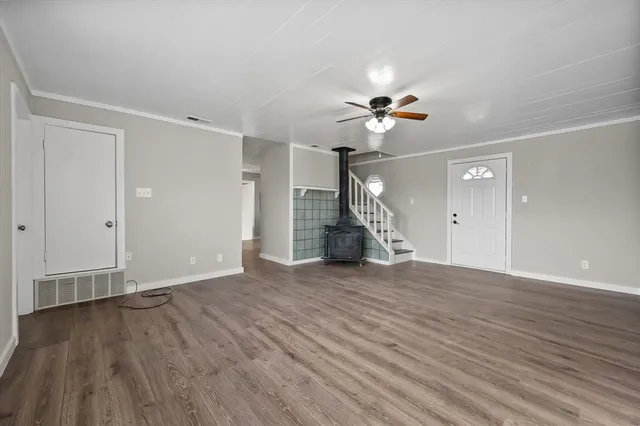 a view of a kitchen with a sink wooden floor and a window