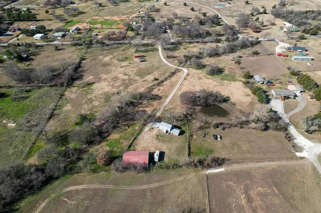an aerial view of a house with a yard