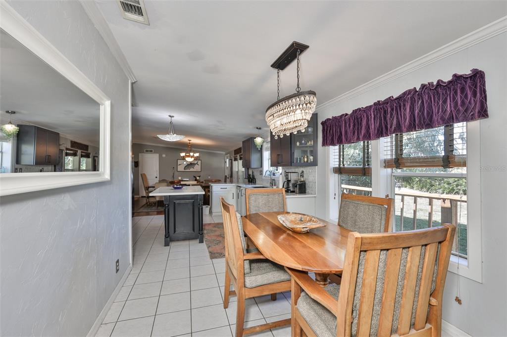 20112 Hobbs Road Wimauma, FL 33598 - Photo 19 of 94 a dining room with furniture a chandelier and window