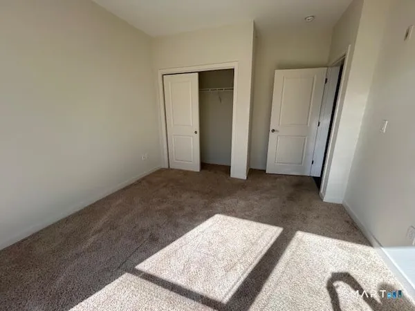 a bathroom with a granite countertop toilet and a sink