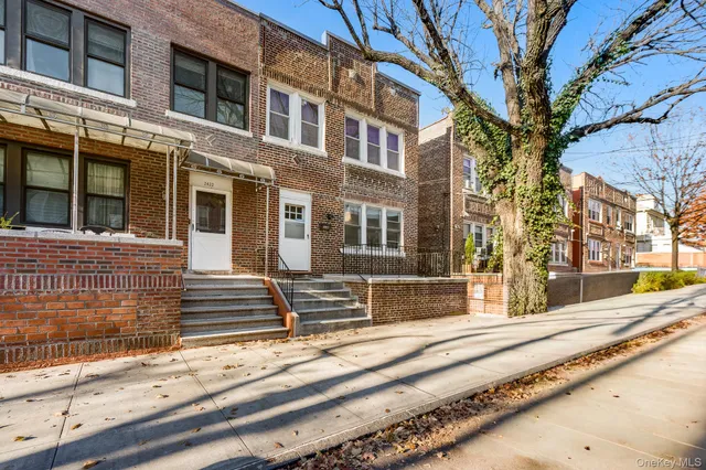 a view of a brick building next to a road