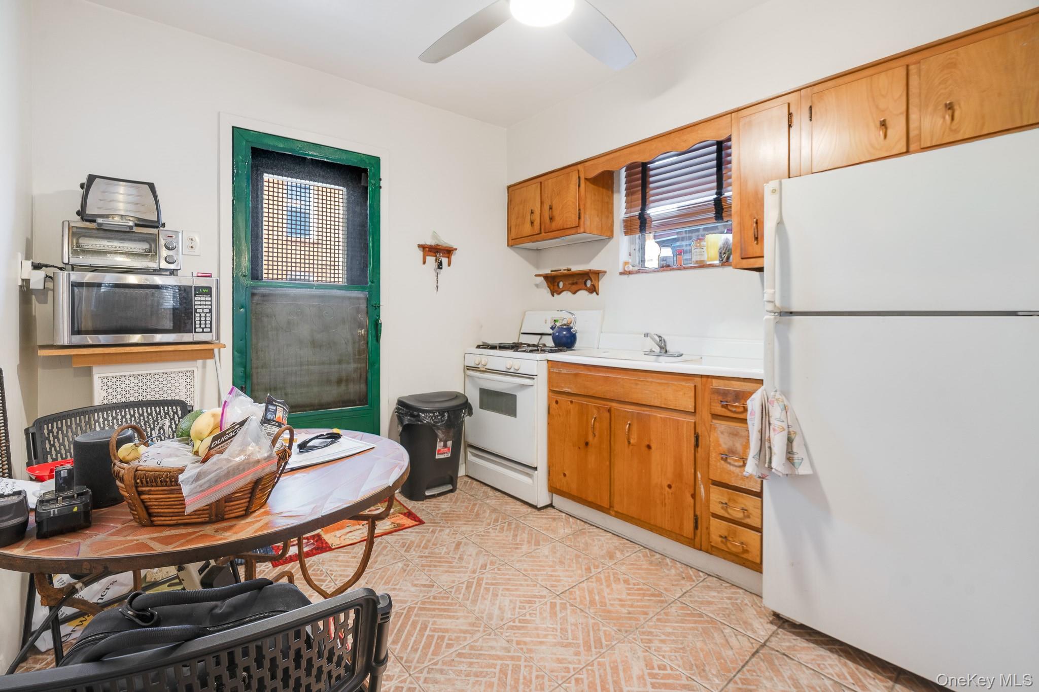 2437 Buck Street Bronx, NY 10461 - Photo 13 of 38 a kitchen with a sink appliances and cabinets