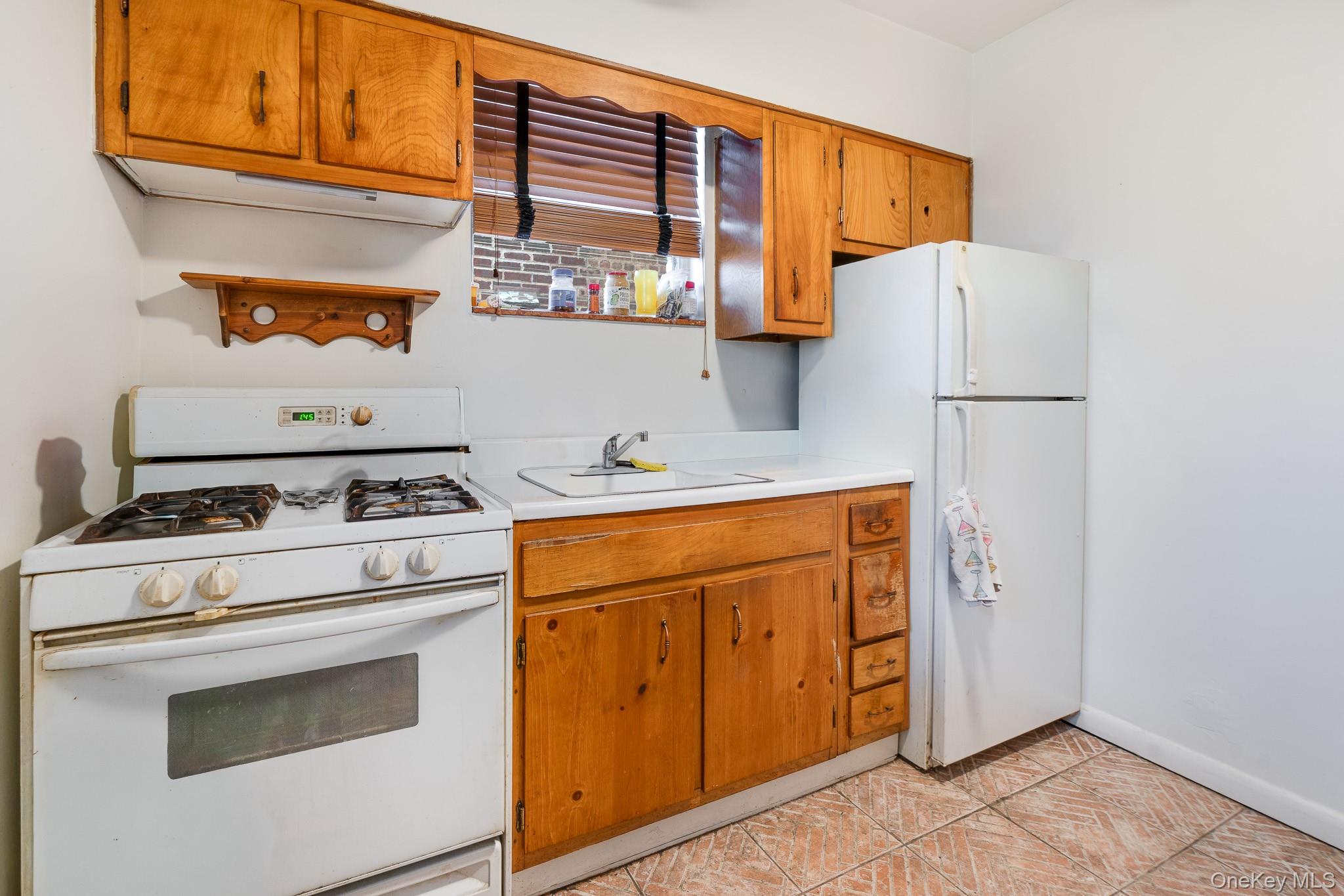 2437 Buck Street Bronx, NY 10461 - Photo 14 of 38 a kitchen with stainless steel appliances a stove and a refrigerator