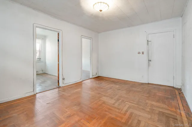 an empty room with windows and closet