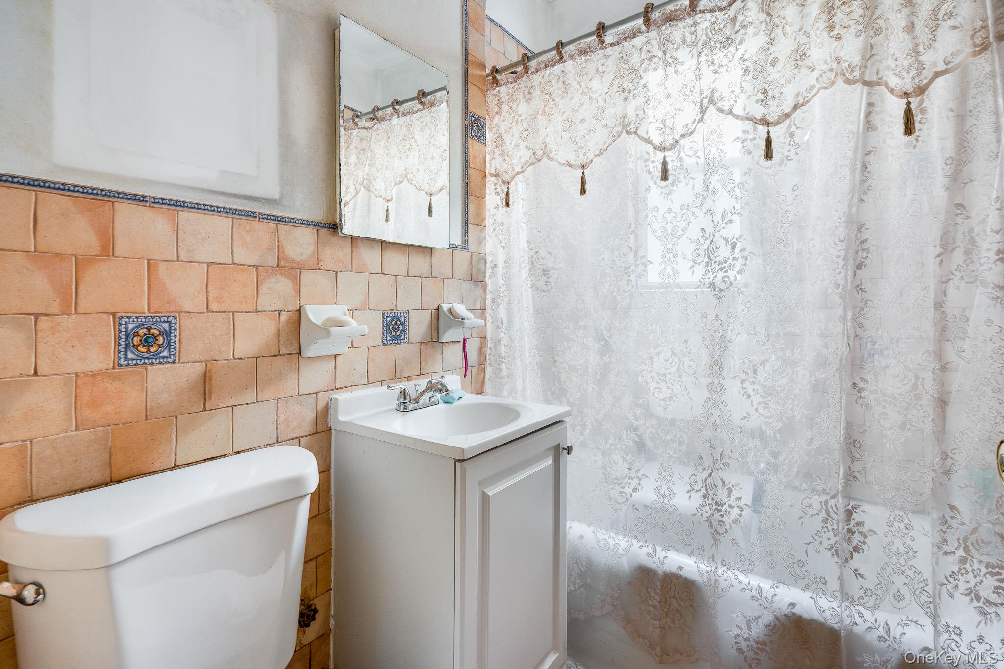 2437 Buck Street Bronx, NY 10461 - Photo 25 of 38 a bathroom with a sink toilet and shower