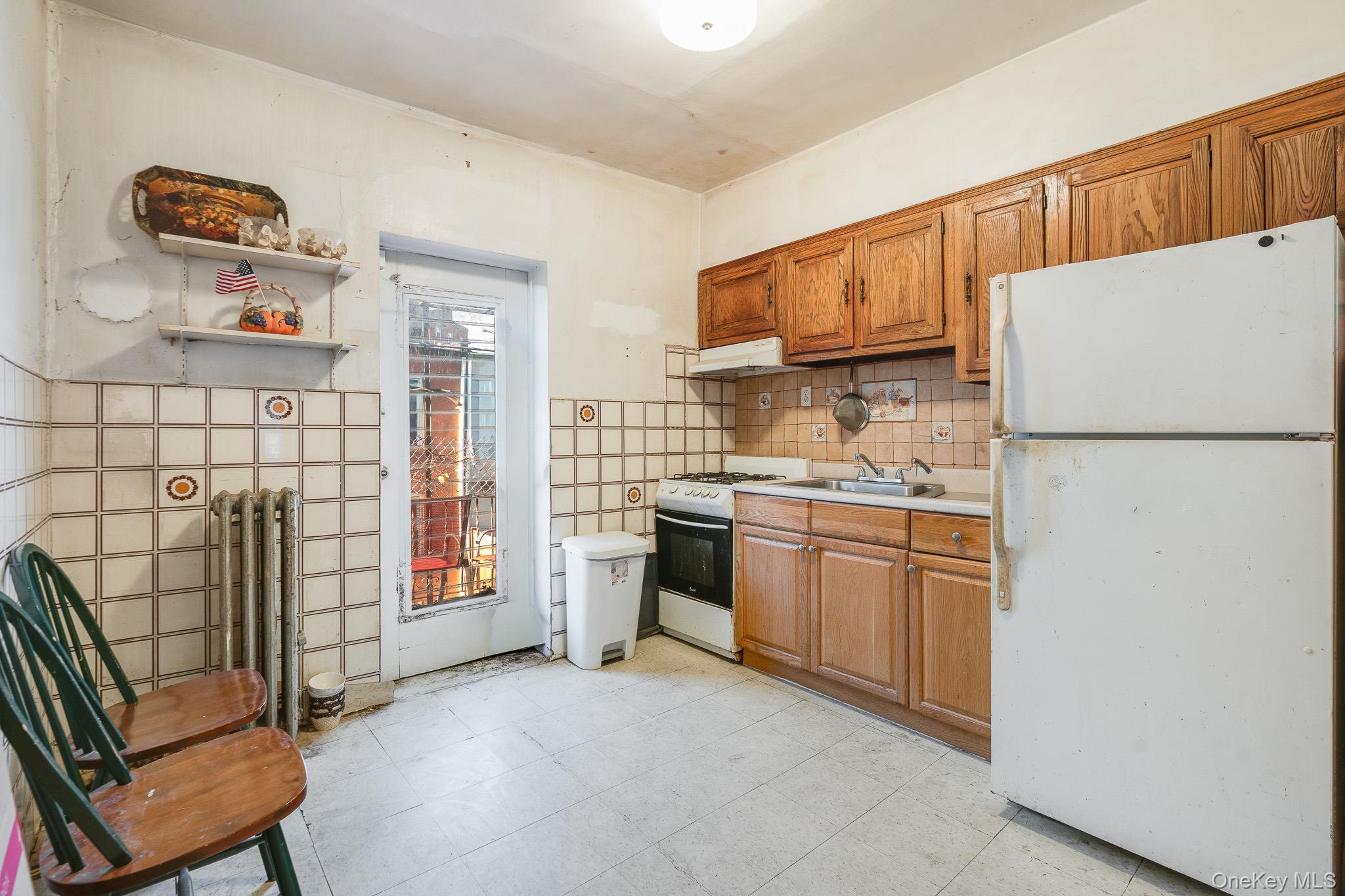 2437 Buck Street Bronx, NY 10461 - Photo 27 of 38 a kitchen with refrigerator and cabinets
