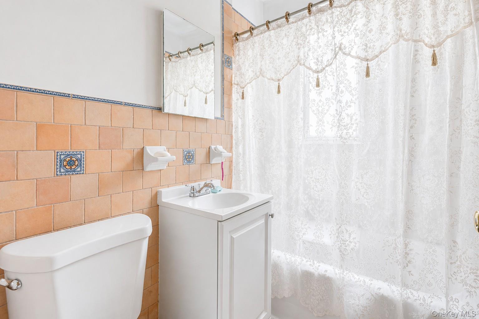 2437 Buck Street Bronx, NY 10461 - Photo 28 of 38 a bathroom with a sink a toilet and shower