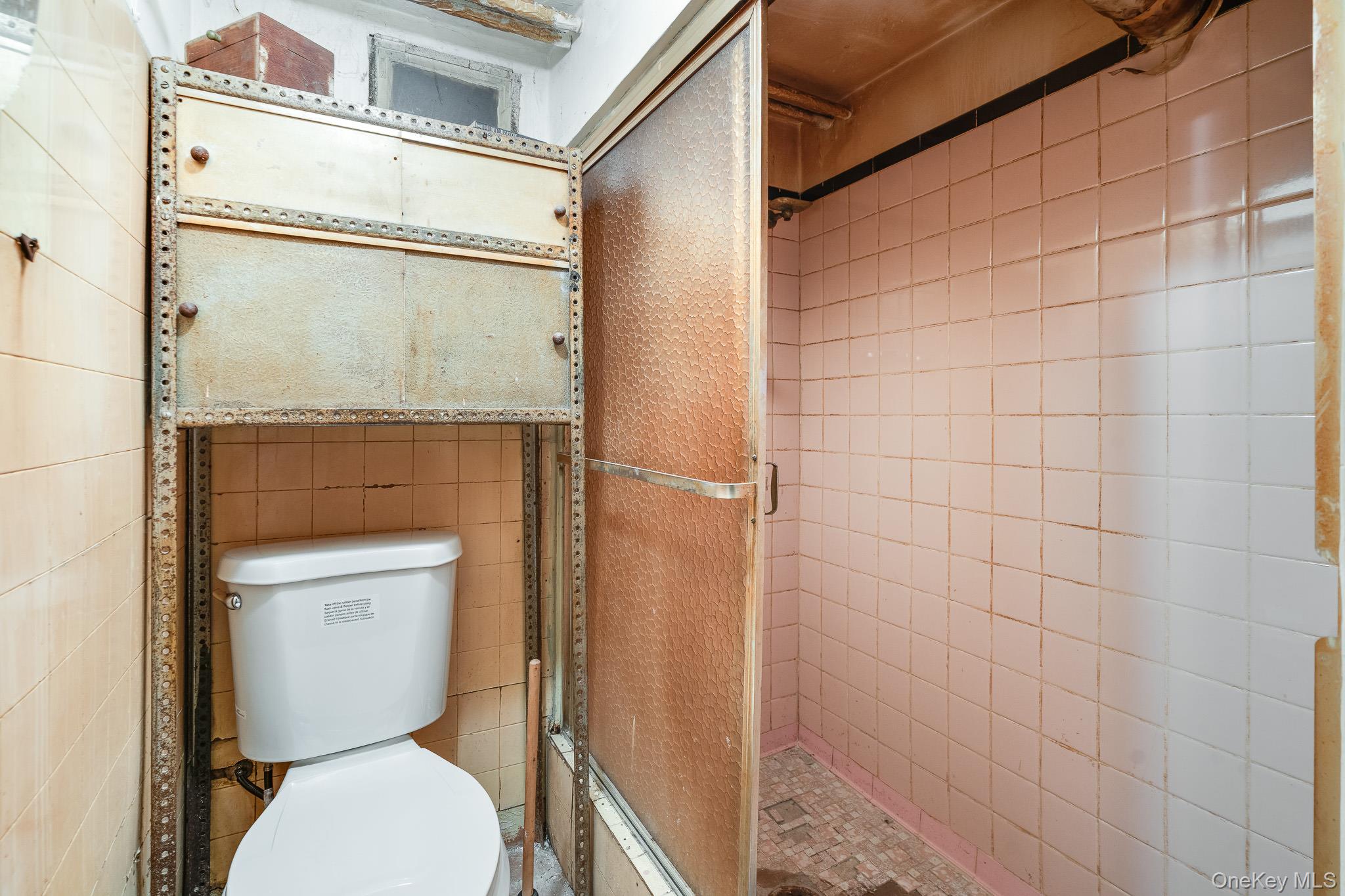 2437 Buck Street Bronx, NY 10461 - Photo 34 of 38 a bathroom with a toilet and a shower