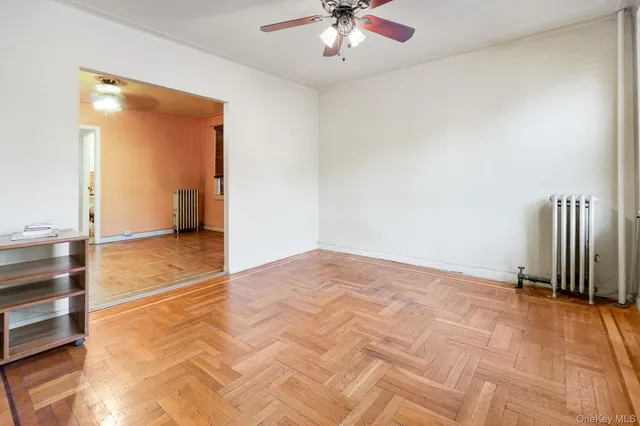 a view of an empty room with a ceiling fan