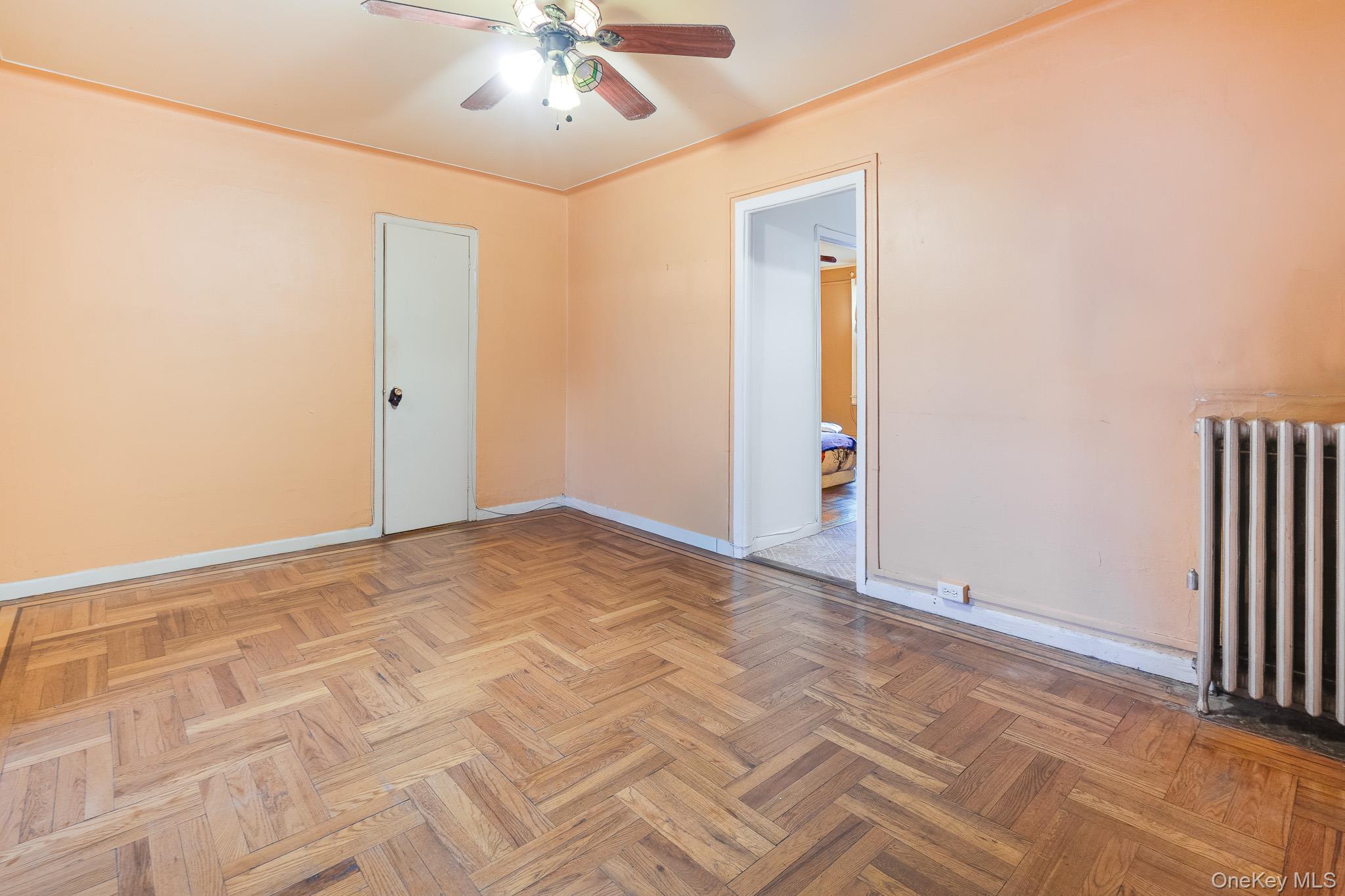 2437 Buck Street Bronx, NY 10461 - Photo 8 of 38 an empty room with fan and entrance