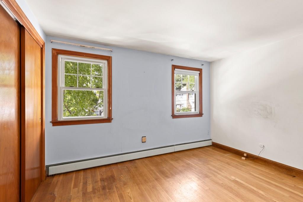 19 Ronald Road Arlington, MA 02474 - Photo 12 of 28 a view of an empty room with wooden floor and a window