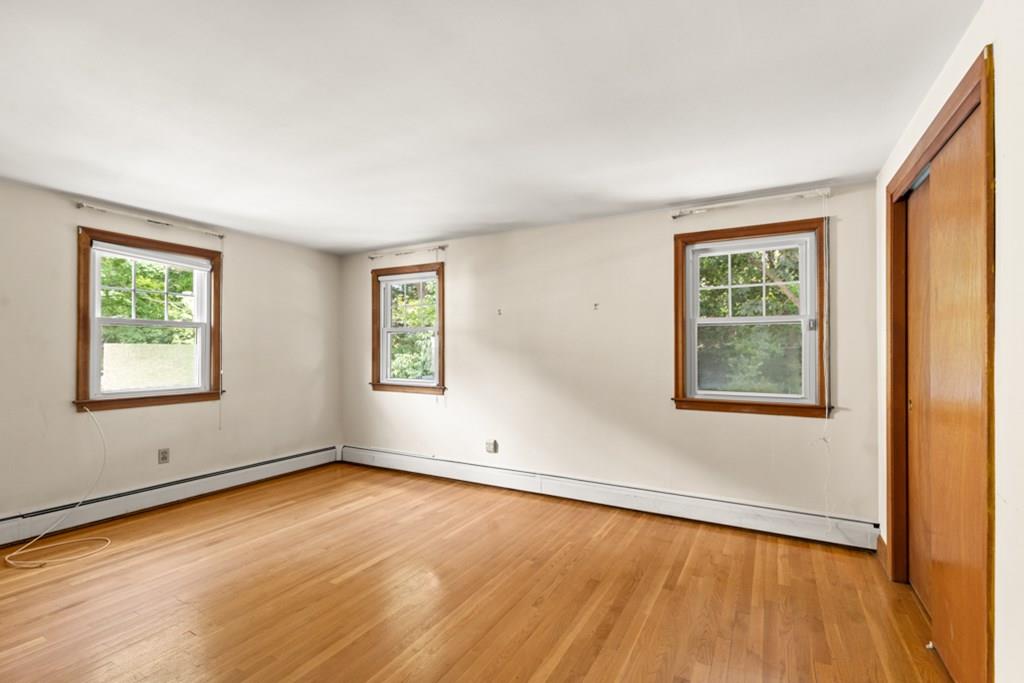 19 Ronald Road Arlington, MA 02474 - Photo 13 of 28 a view of an empty room with wooden floor and a window