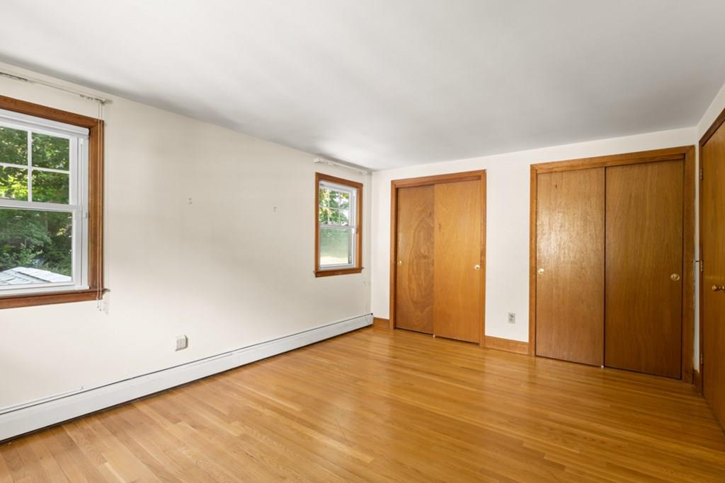 19 Ronald Road Arlington, MA 02474 - Photo 14 of 28 a view of an empty room with wooden floor and a window