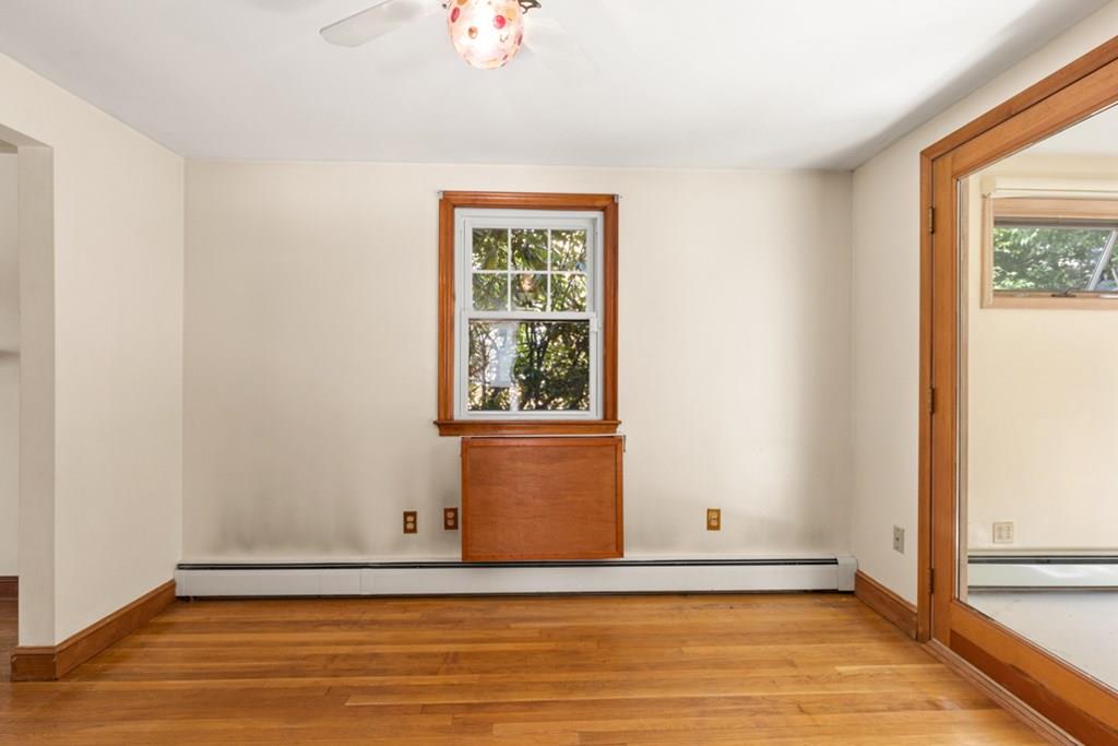 19 Ronald Road Arlington, MA 02474 - Photo 16 of 28 a view of an empty room with wooden floor and a window