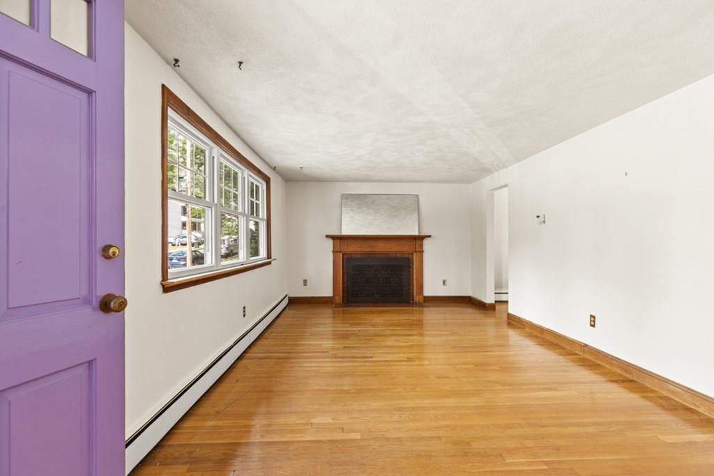 19 Ronald Road Arlington, MA 02474 - Photo 3 of 28 a view of an empty room with window and wooden floor