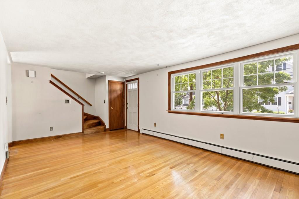 19 Ronald Road Arlington, MA 02474 - Photo 5 of 28 an empty room with wooden floor and windows