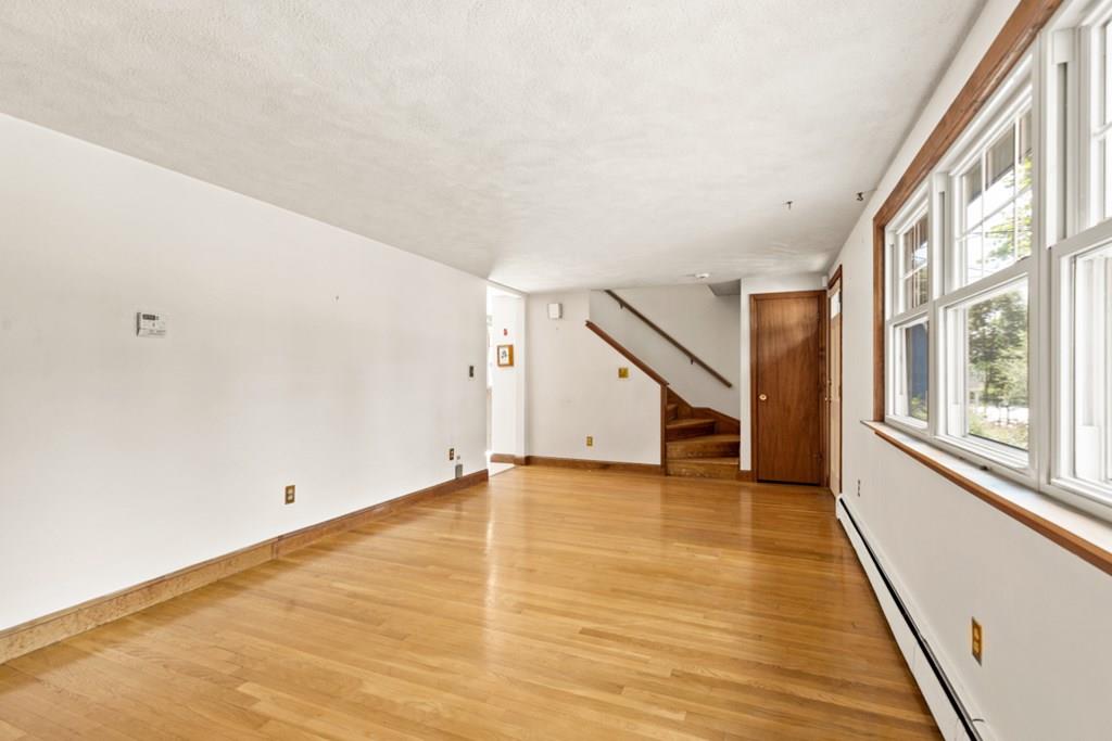 19 Ronald Road Arlington, MA 02474 - Photo 6 of 28 a view of an empty room with wooden floor and stairs